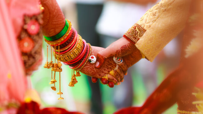 Hands adorned with bangles and mehendi